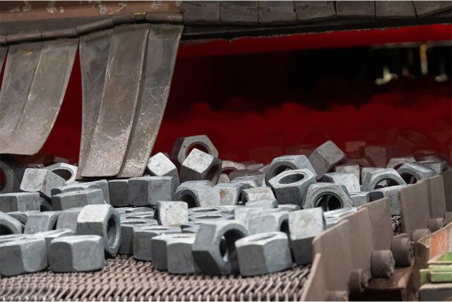 Large diameter nuts on a conveyor belt at the Dyson Manufacturing facility.