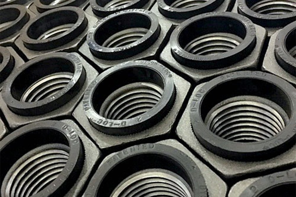 Multiple D-Loc nuts are lined up after being manufactured by Dyson Corporation in the USA.